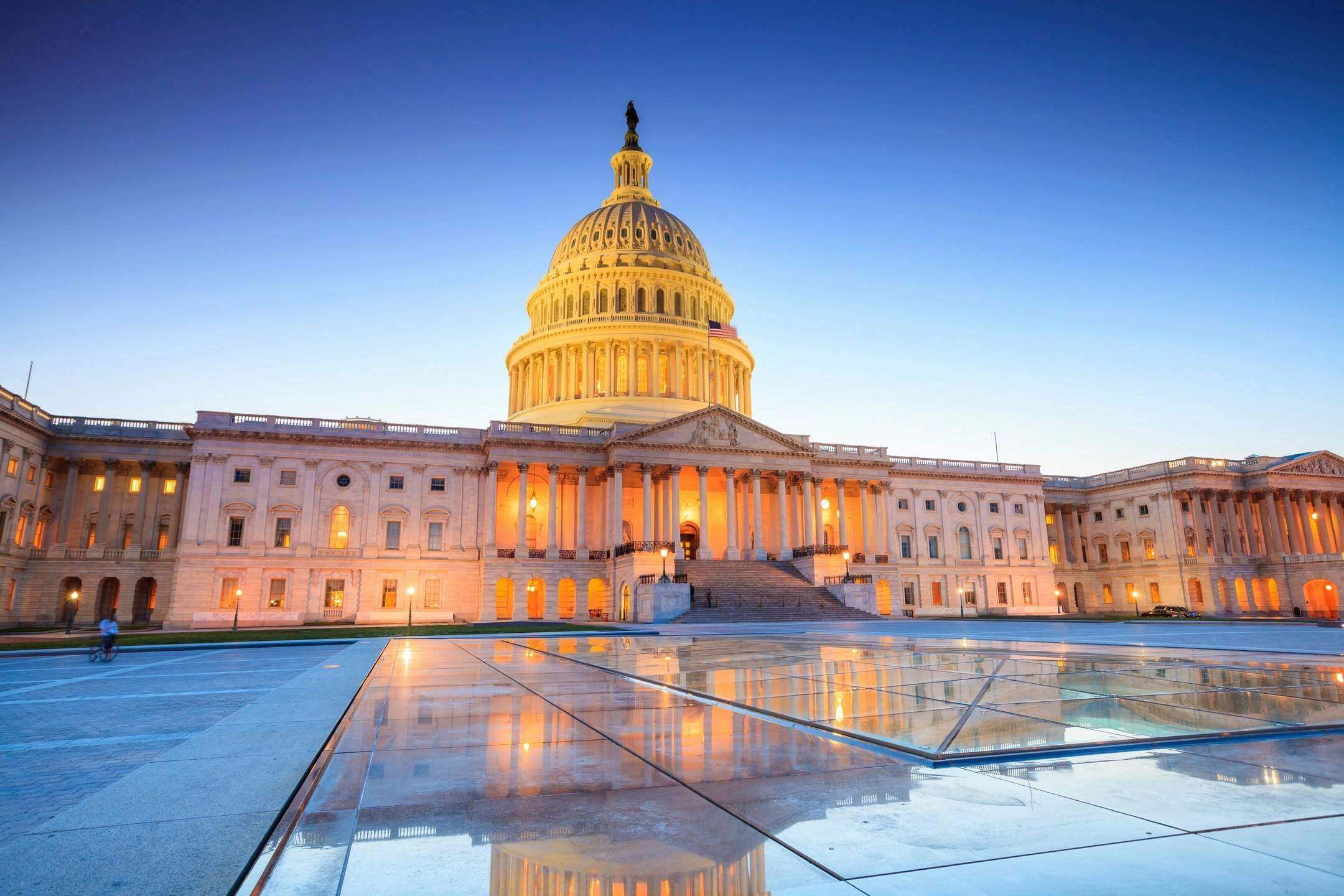 U.S. Capitol Building at sunset reflection.